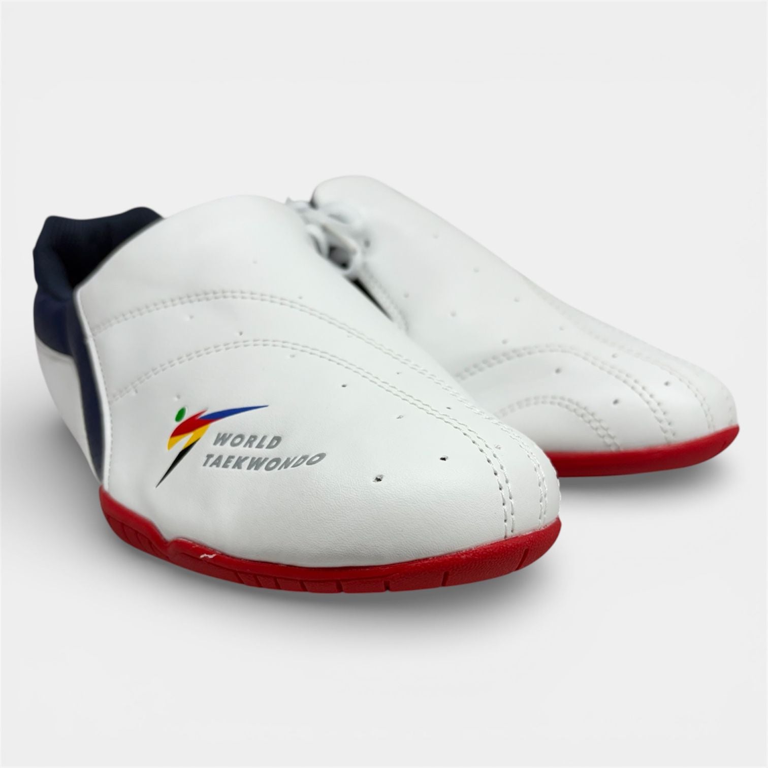 White taekwondo shoes with red soles on a white background