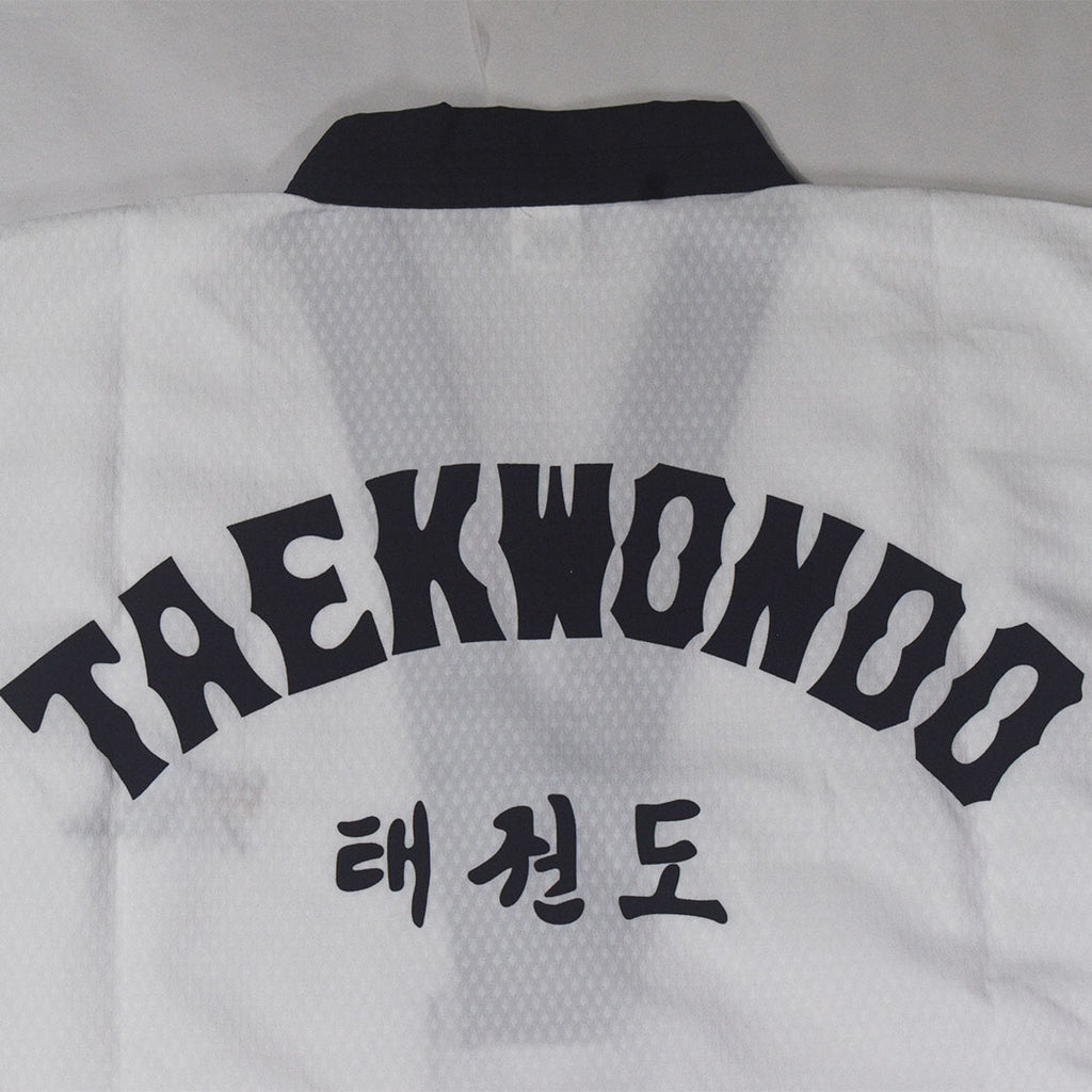 White martial arts uniform with 'TAEKWONDO' printed on it against a white background